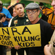 A protester holds a sign that reads, ‘NRA Stop Killing Our Kids’, outside the courtroom where Nikolas Cruz, 19, a former student at Marjory Stoneman Douglas High School in Parkland, Florida, was having a bond hearing in front of Broward Judge Kim Mollica at the Broward County Courthouse on February 15, 2018 in Fort Lauderdale, Florida. Mr. Cruz is possibly facing 17 counts of premeditated murder in the school shooting. (Photo by Charles Trainor Jr. - Pool/Getty Images).